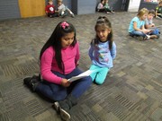 picture of second grade students reading to preschool students