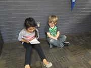 picture of second grade students reading to preschool students